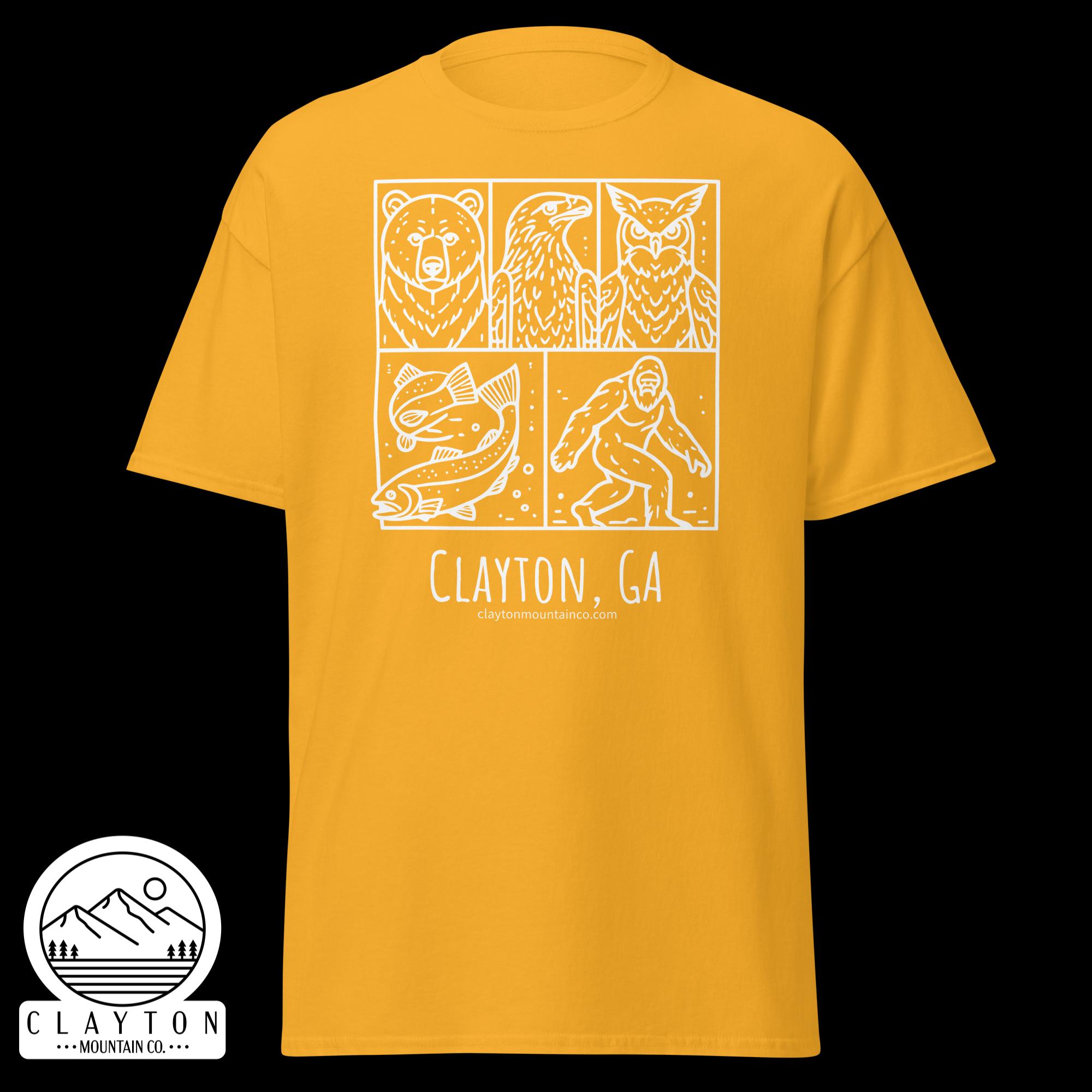 unisex-classic-tee-gold-front-6a2e6635abd84jpg - Clayton Mountain Co. Yellow t-shirt displaying a white boxed design with a bear, eagle, owl, and fish, plus the text 'Clayton, GA' beneath.