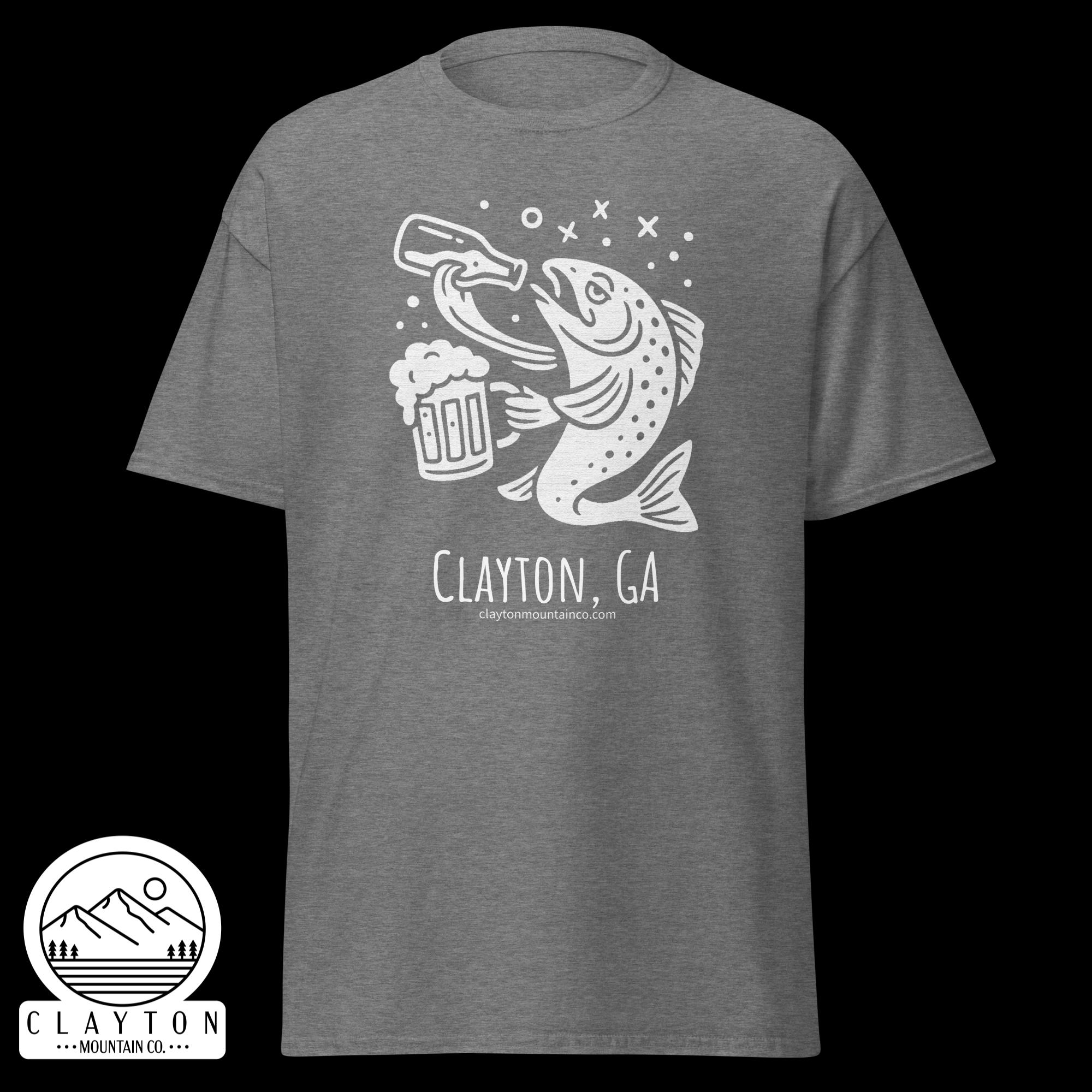 unisex-classic-tee-graphite-heather-front-6a2e5d89b3576jpg - Clayton Mountain Co. Gray T-shirt with a white graphic of a jumping fish and beer mug, plus 'Clayton, GA' text.