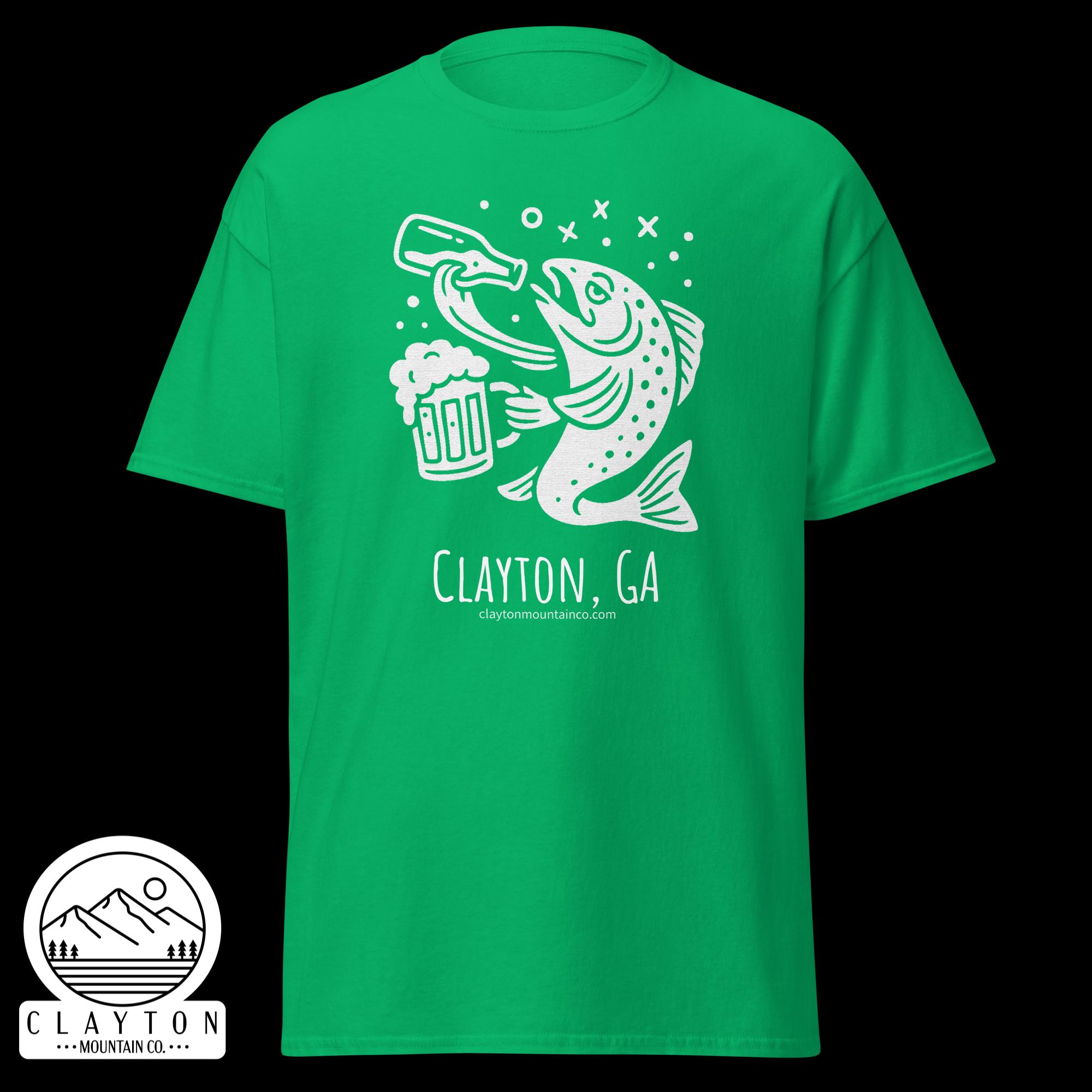 unisex-classic-tee-irish-green-front-6a2e5d89a2f06jpg - Clayton Mountain Co. Green t-shirt displaying a white illustrative design of a fish biting a beer mug with bubbles around, plus a circular Clayton Mountain Co. logo in the bottom left corner.