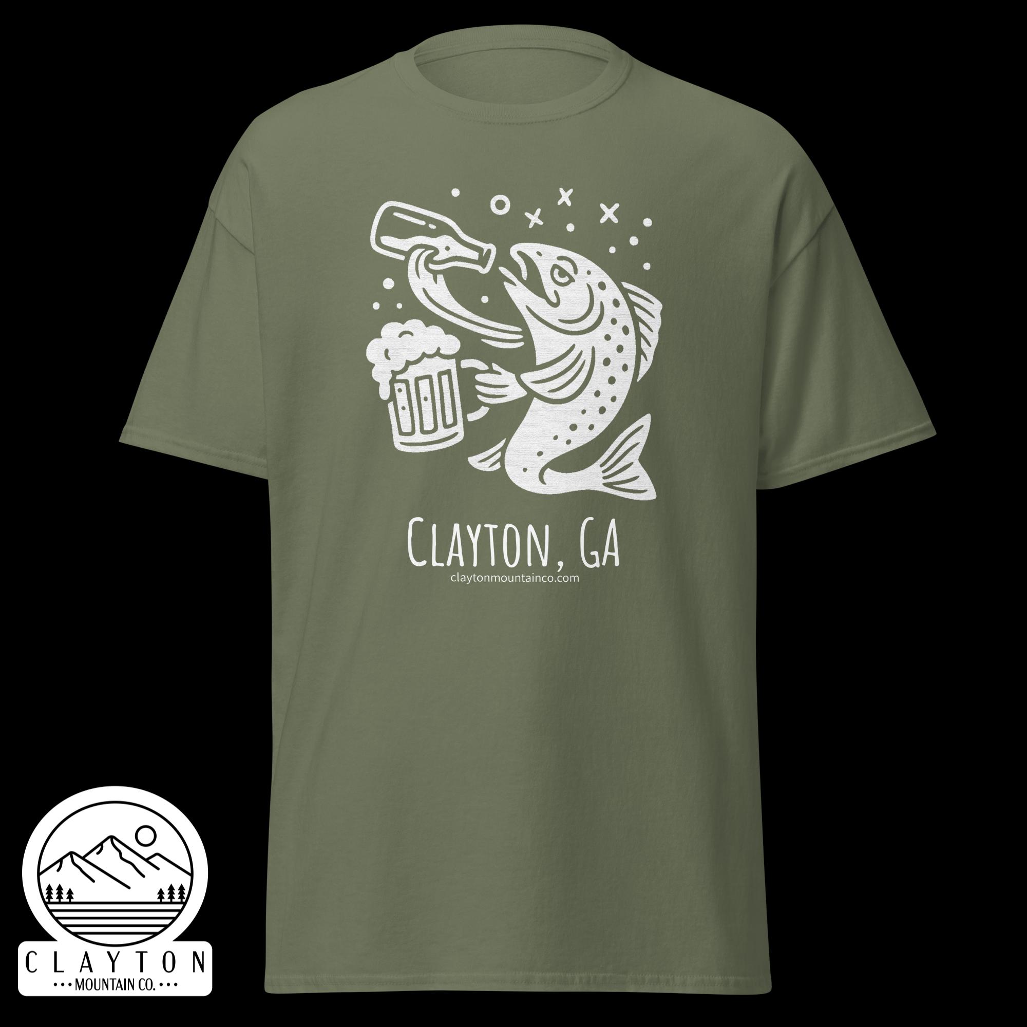 unisex-classic-tee-military-green-front-6a2e5d898fc6bjpg - Clayton Mountain Co. Olive green T‑shirt with a white trout illustration holding a beer mug and Clayton, GA text with a mountain logo in the corner.