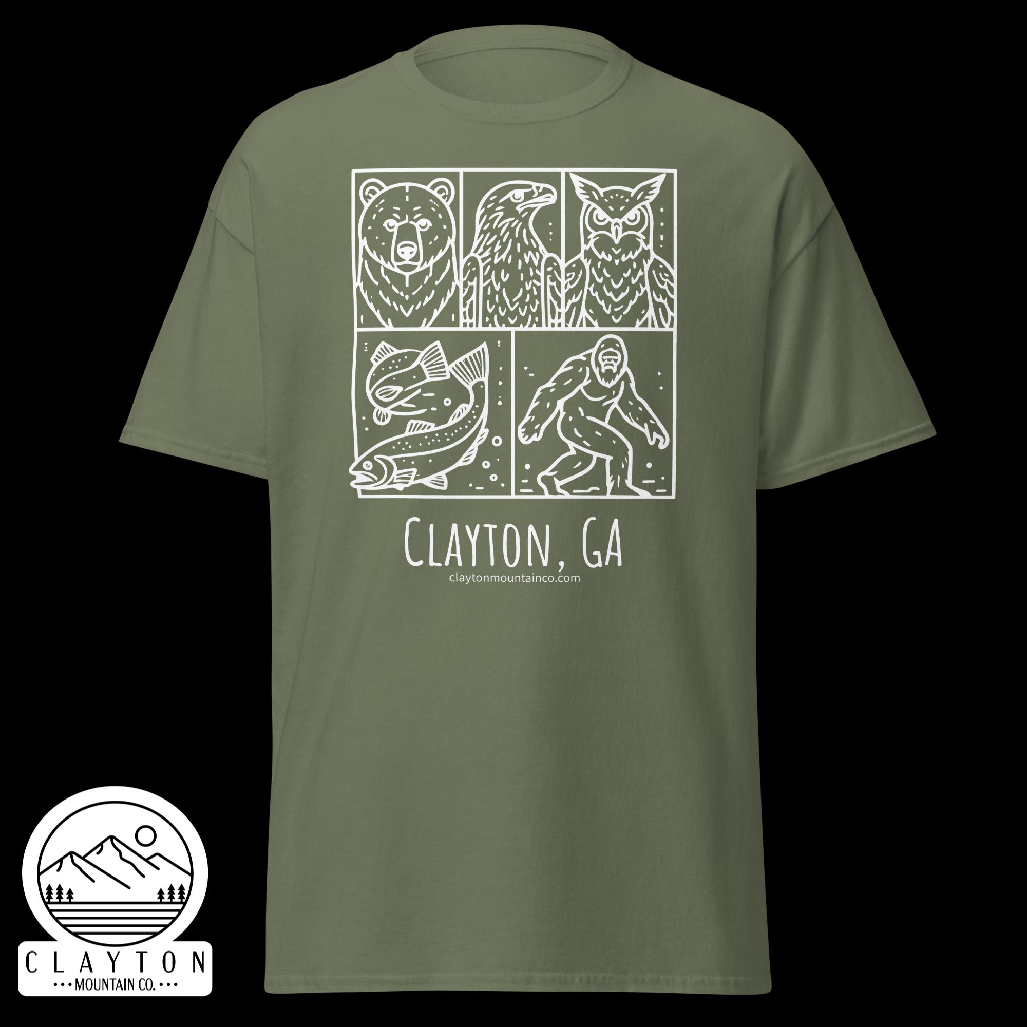 unisex-classic-tee-military-green-front-6a2e6635ae0fdjpg - Clayton Mountain Co. Olive green T-shirt with a white three-panel wildlife illustration (bear, bird, owl) and the text Clayton, GA below; includes a circular mountain logo sticker in the corner and the site claytonmountainco.com.