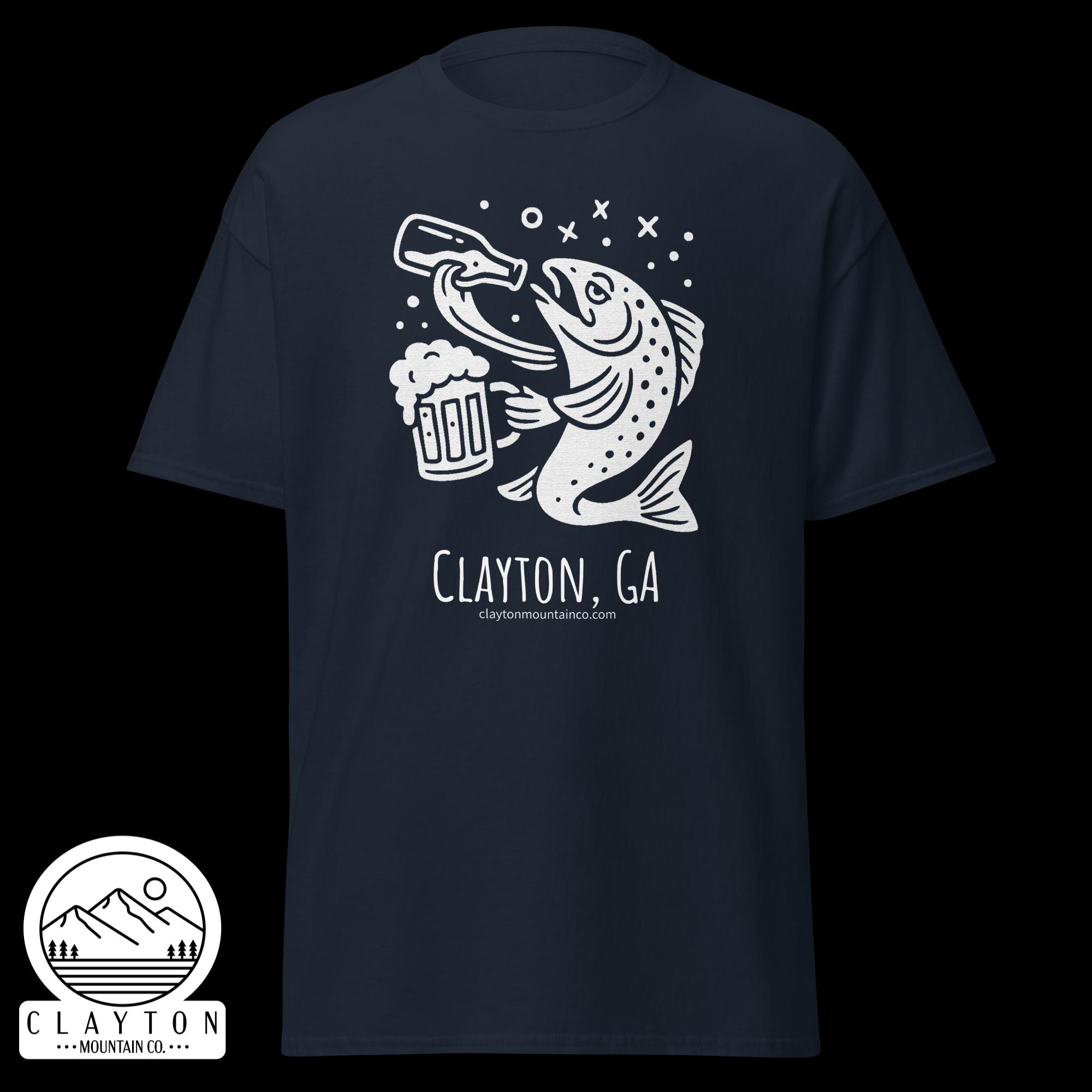 unisex-classic-tee-navy-front-6a2e5d89a4e1ejpg - Clayton Mountain Co. Navy T-shirt with a white line-art fish holding a beer mug, jumping with bubbles, near a circular mountain logo and Clayton, GA text.
