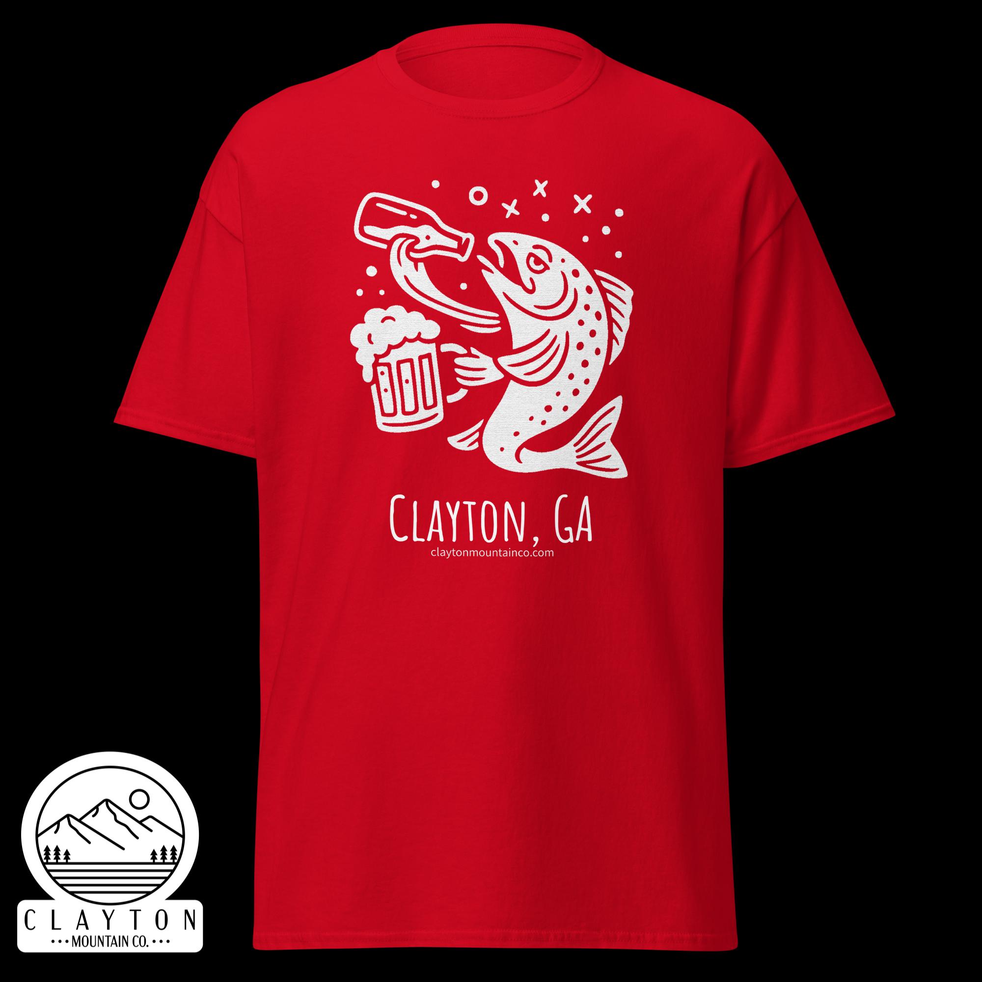 unisex-classic-tee-red-front-6a2e5d89a8d7ajpg - Clayton Mountain Co. Red T-shirt with a white fish illustration holding a beer mug and bubbly accents; 'Clayton, GA' branding visible on the print.