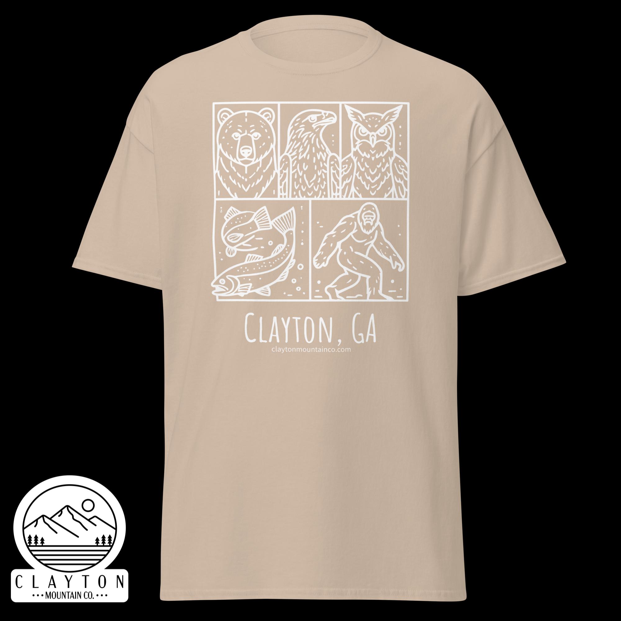 unisex-classic-tee-sand-front-6a2e6635b27e0jpg - Clayton Mountain Co. Beige T-shirt with white three-panel wildlife illustration (bear, eagle, owl) and a round mountain logo reading Clayton, GA with site text partially visible.
