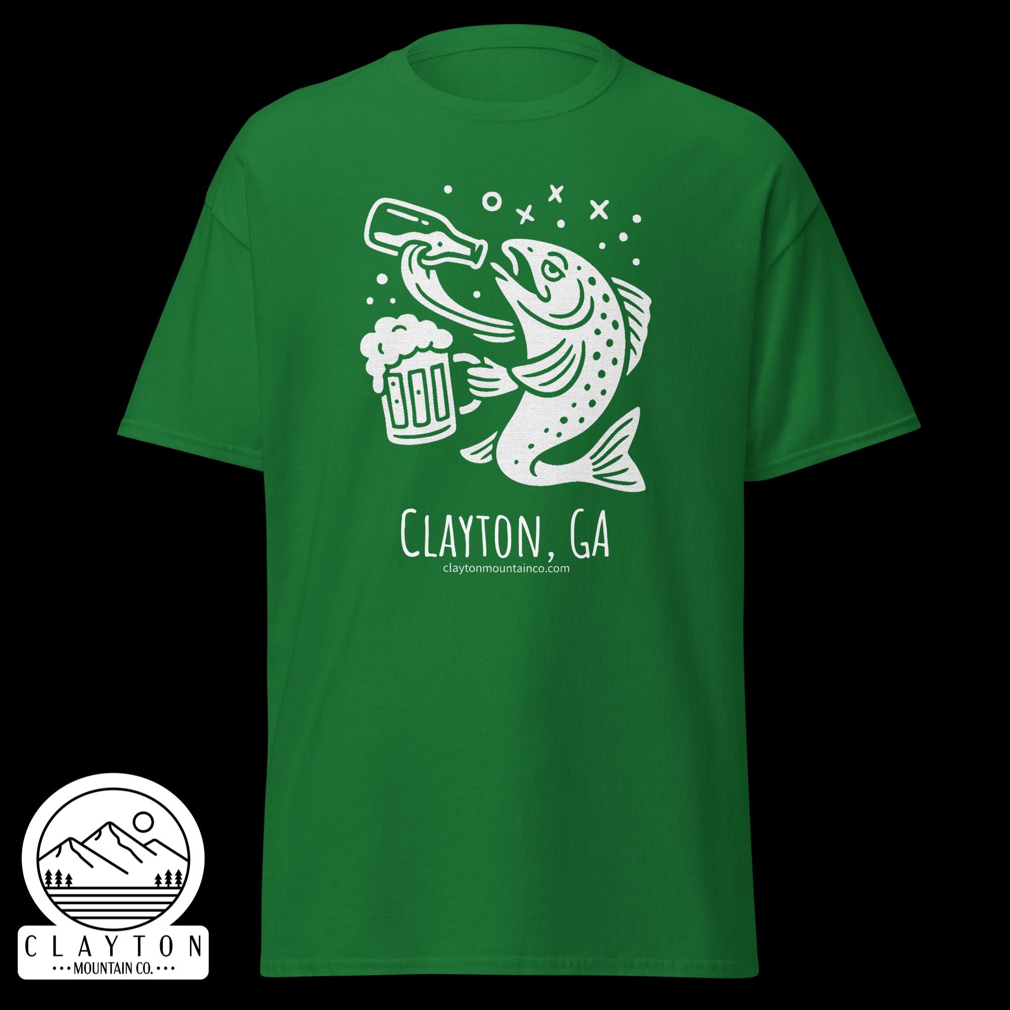 unisex-classic-tee-turf-green-front-6a2e5d89b10ffjpg - Clayton Mountain Co. Green T-shirt featuring a white graphic of a jumping fish over a beer mug, with bubbles around it.